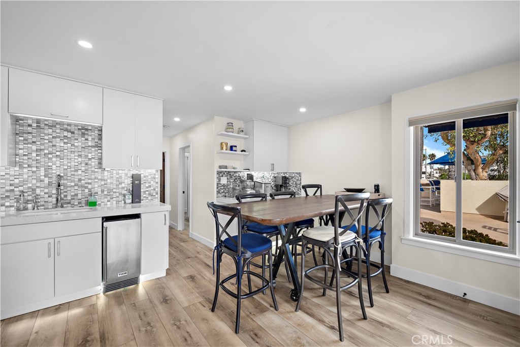 711 Pacific Coast Highway, Unit 330 Huntington Beach, CA 92648 - Photo 12 of 54 a view of a dining room with furniture and window