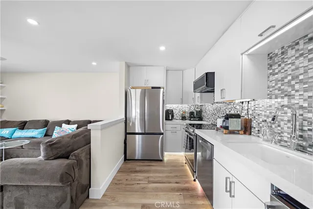 a kitchen with refrigerator and cabinets