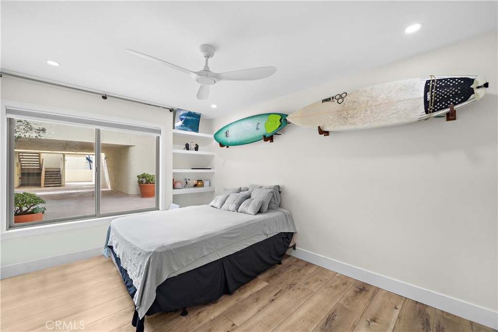 711 Pacific Coast Highway, Unit 330 Huntington Beach, CA 92648 - Photo 16 of 54 a bedroom with a bed dresser and a window