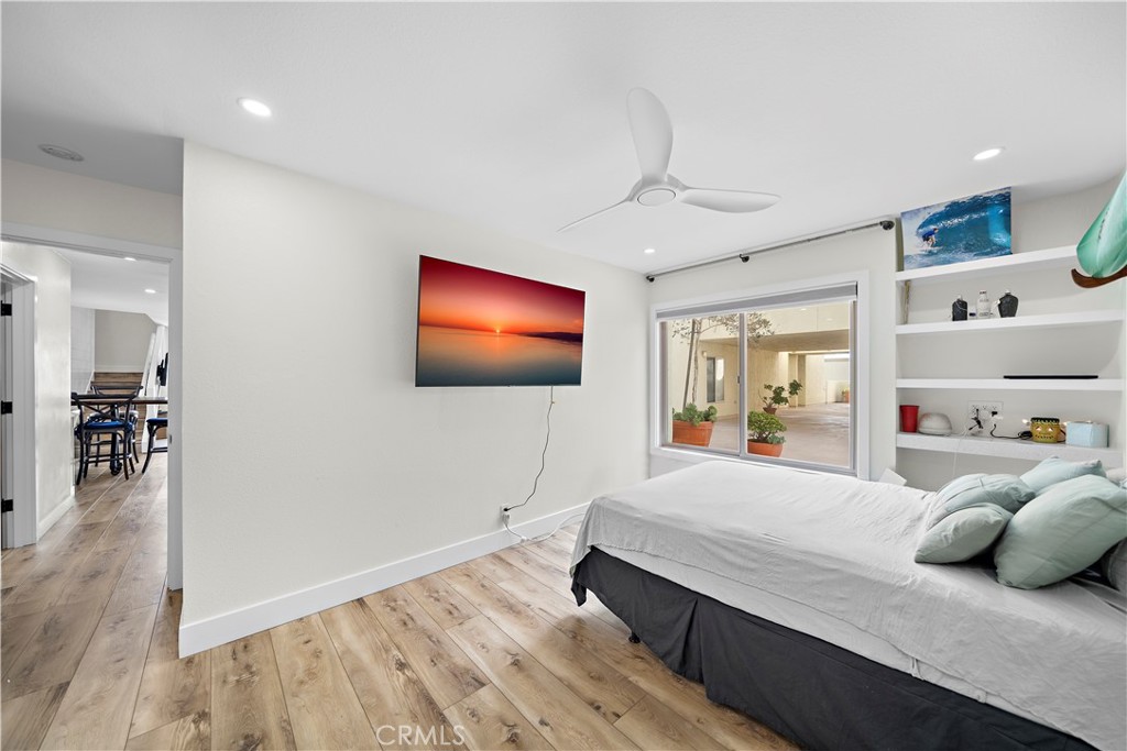 711 Pacific Coast Highway, Unit 330 Huntington Beach, CA 92648 - Photo 17 of 54 a bedroom with a bed and a flat screen tv