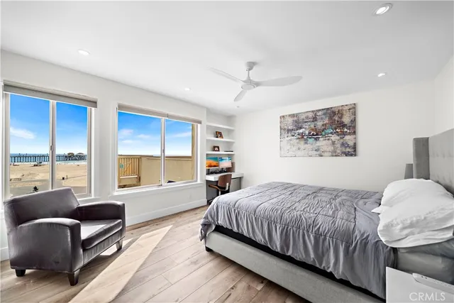 a bedroom with a bed a couch and a large window