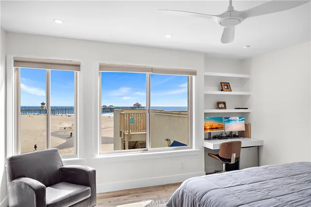 a bedroom with a bed and a large window with the outer view