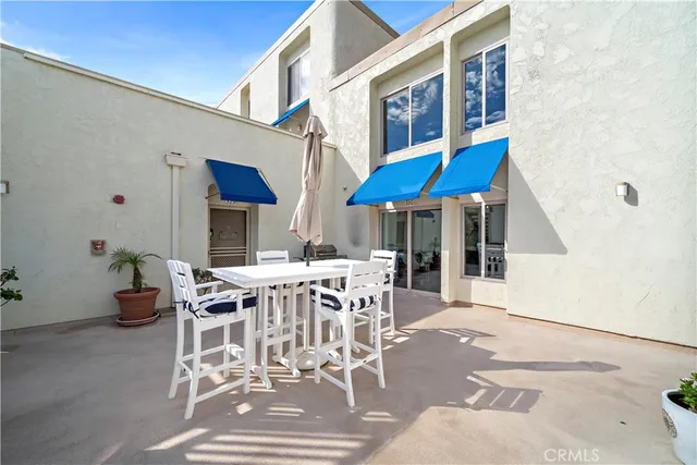 a view of a patio with table and chairs with wooden floor and fence