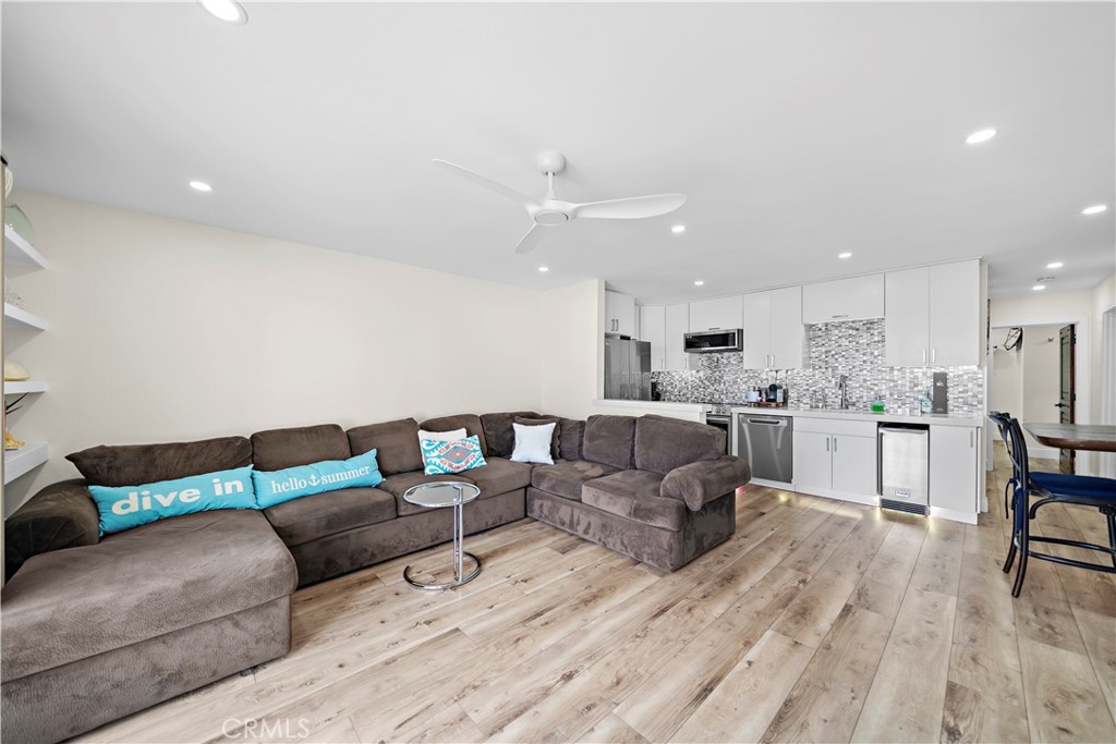 711 Pacific Coast Highway, Unit 330 Huntington Beach, CA 92648 - Photo 10 of 54 a living room with furniture and kitchen view