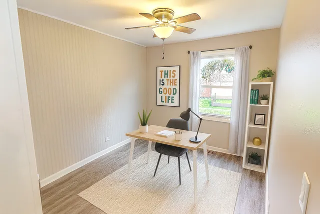 a workspace with wooden floor and a window