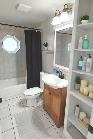a bathroom with a sink toilet and shower