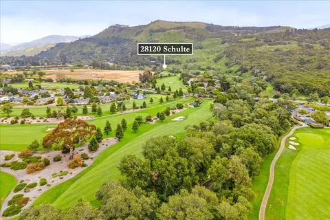 a view of a field with a mountain in the background