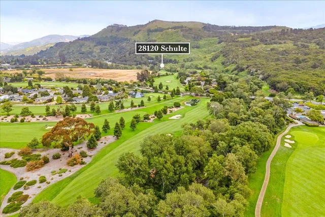 a view of a field with a mountain in the background