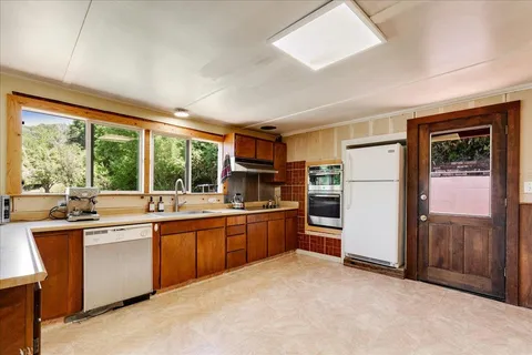 a kitchen with a sink stove and refrigerator