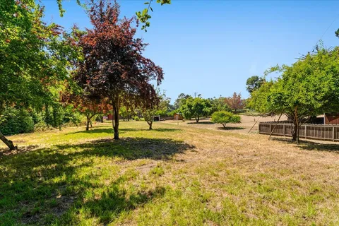 a backyard of a house with a yard and outdoor seating