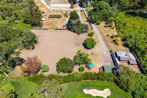 an aerial view of lake residential house with outdoor space and trees around