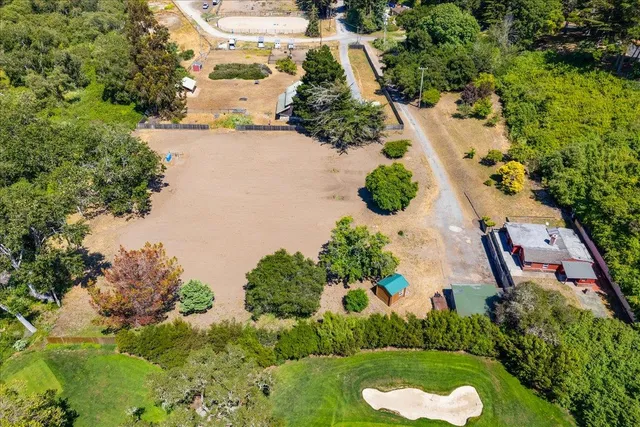 an aerial view of lake residential house with outdoor space and trees around
