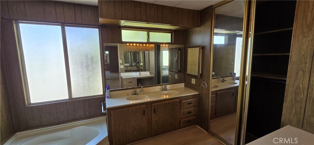 9391 California Avenue, Unit 80 Riverside, CA 92503 - Photo 15 of 28 a bathroom with a sink a mirror and a bathtub