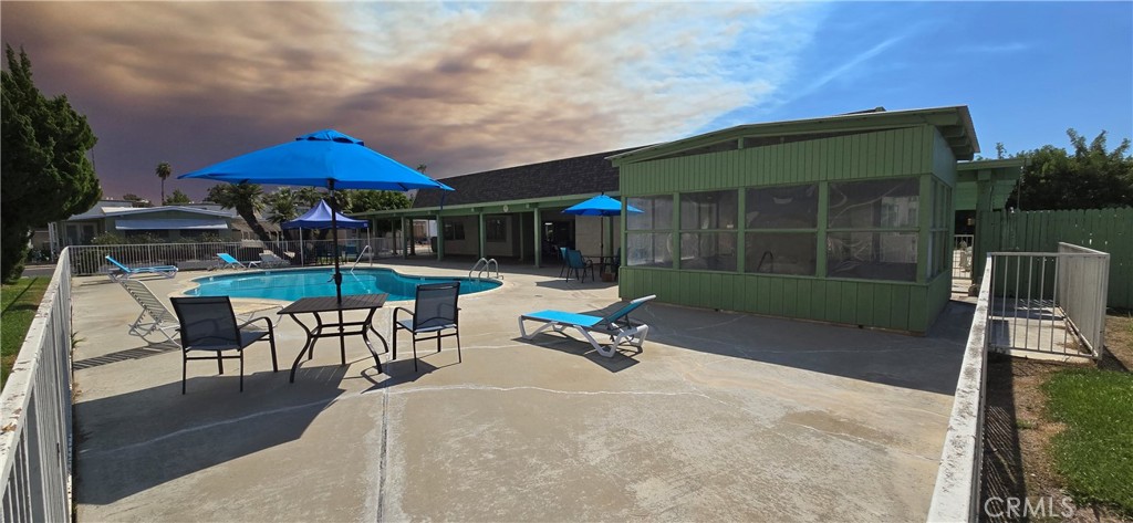 9391 California Avenue, Unit 80 Riverside, CA 92503 - Photo 20 of 28 an outdoor space with patio and white umbrellas