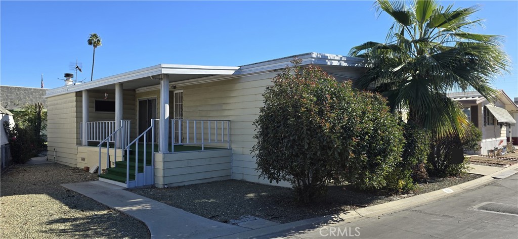 9391 California Avenue, Unit 80 Riverside, CA 92503 - Photo 2 of 28 a front view of a house with a yard