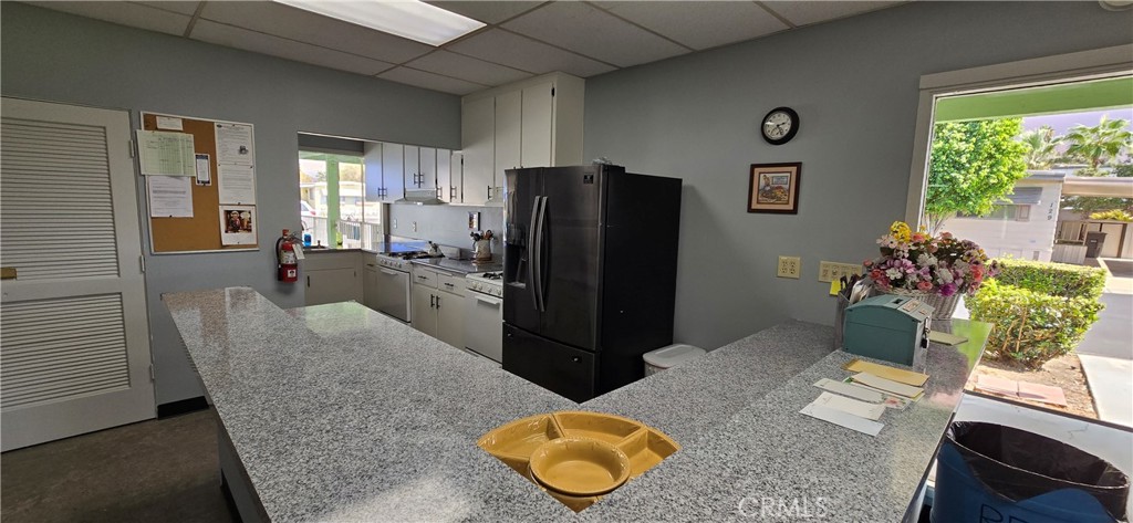 9391 California Avenue, Unit 80 Riverside, CA 92503 - Photo 24 of 28 a living room with furniture potted plant and a window