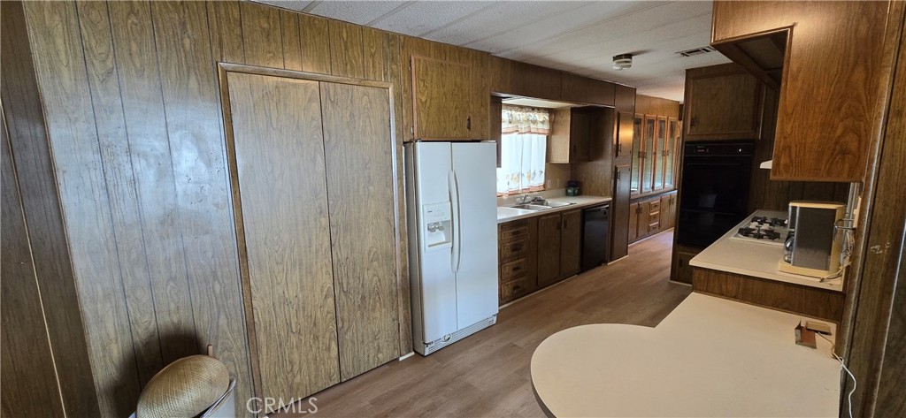 9391 California Avenue, Unit 80 Riverside, CA 92503 - Photo 10 of 28 a kitchen with sink refrigerator and stove