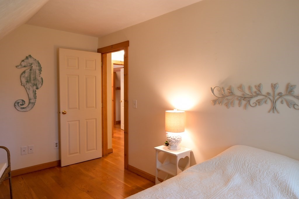 6 Michael Road Bourne, MA 02559 - Photo 26 of 41 a bedroom with a bed and a chandelier