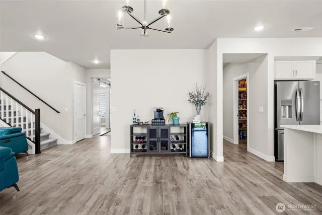 a dining room with furniture and wooden floor