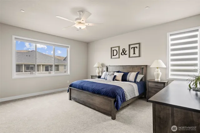 a spacious bedroom with a bed and a window