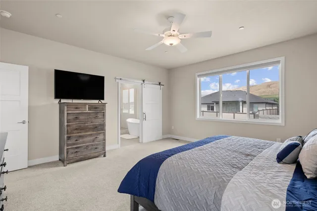 a bedroom with a bed and a television