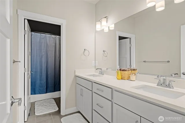 a bathroom with a double vanity sink and a mirror