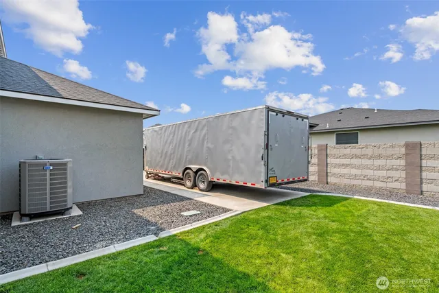 a backyard of a house with table and chairs