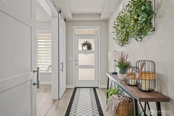 a view of a hallway to a livingroom with furniture
