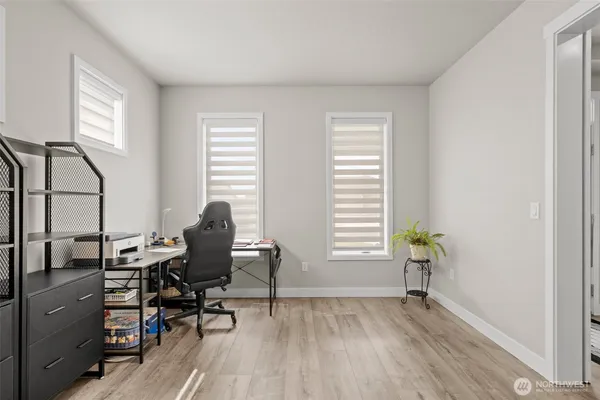 a view of a workspace with furniture and a window