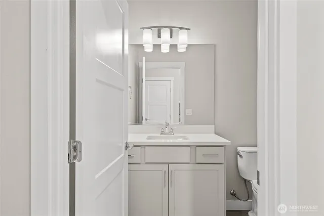a bathroom with a sink vanity and mirror