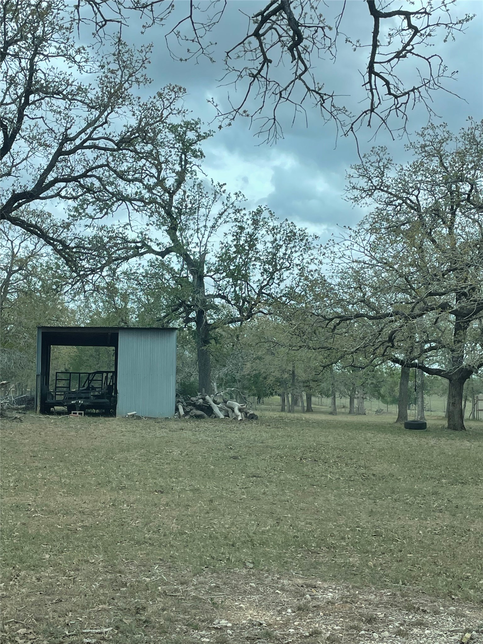 2238 Flash Circle Luling, TX 78648 - Photo 4 of 5 A tranquil landscape offers a clear-span shed and ample space for recreational pursuits.