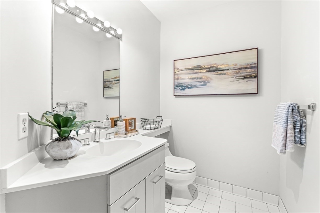 67 Algonquin Road, Unit 67 Newton, MA 02467 - Photo 19 of 38 a bathroom with a sink a toilet and mirror