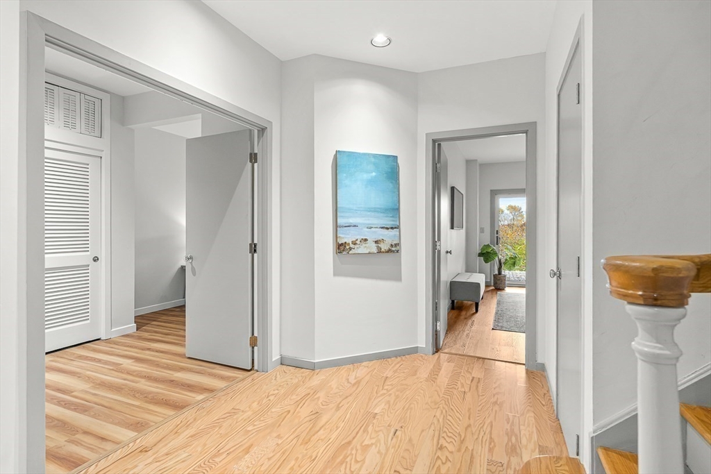 67 Algonquin Road, Unit 67 Newton, MA 02467 - Photo 22 of 38 a view of a livingroom with wooden floor and a refrigerator