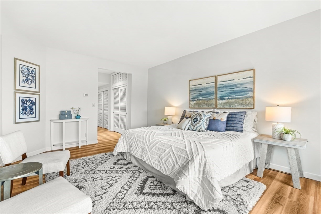 67 Algonquin Road, Unit 67 Newton, MA 02467 - Photo 24 of 38 a bedroom with a bed and wooden floor