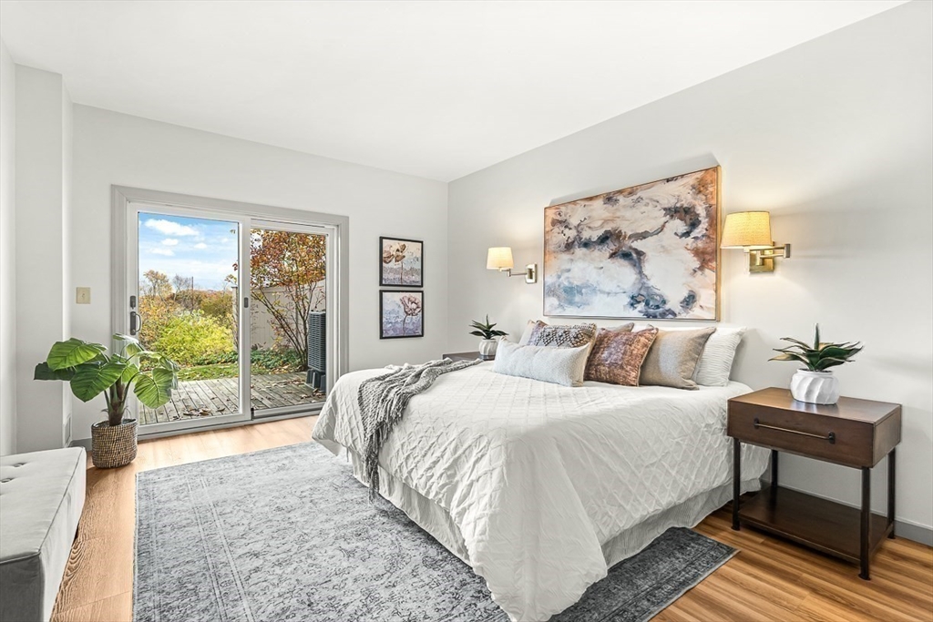 67 Algonquin Road, Unit 67 Newton, MA 02467 - Photo 30 of 38 a bedroom with a bed and a potted plant