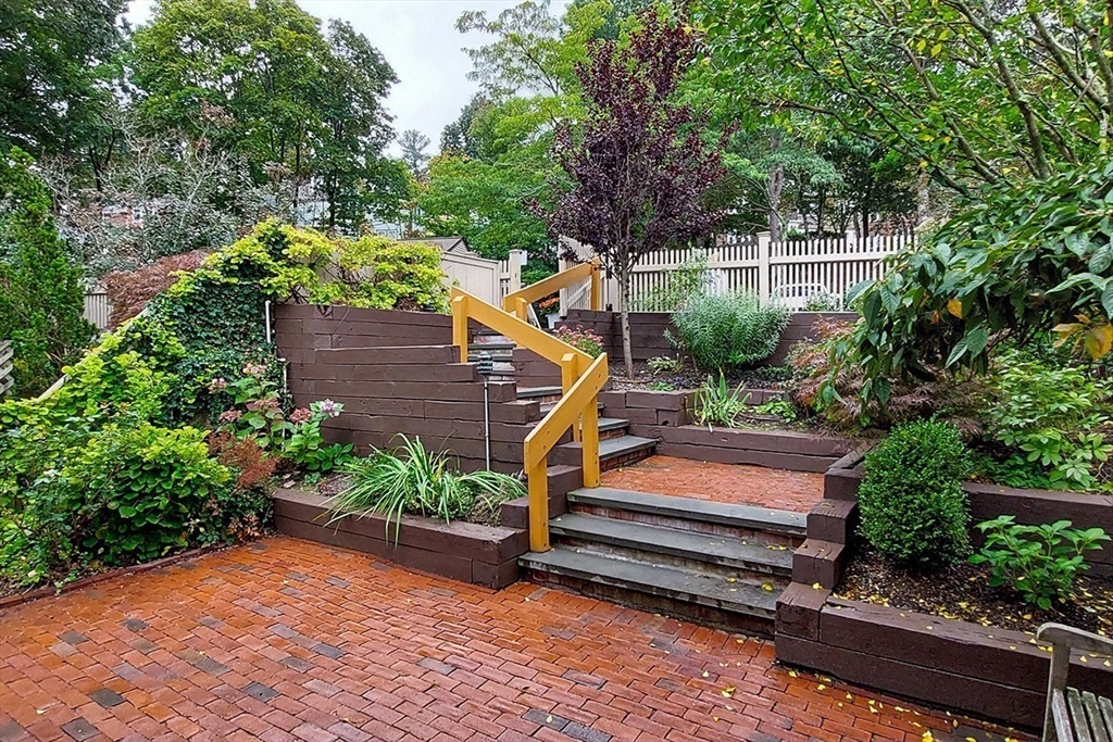 67 Algonquin Road, Unit 67 Newton, MA 02467 - Photo 3 of 38 a backyard of a house with outdoor seating and trees
