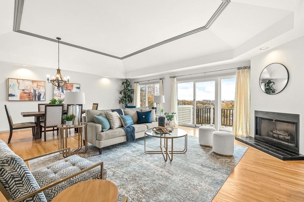 67 Algonquin Road, Unit 67 Newton, MA 02467 - Photo 5 of 38 a living room with furniture a dining table and a fireplace