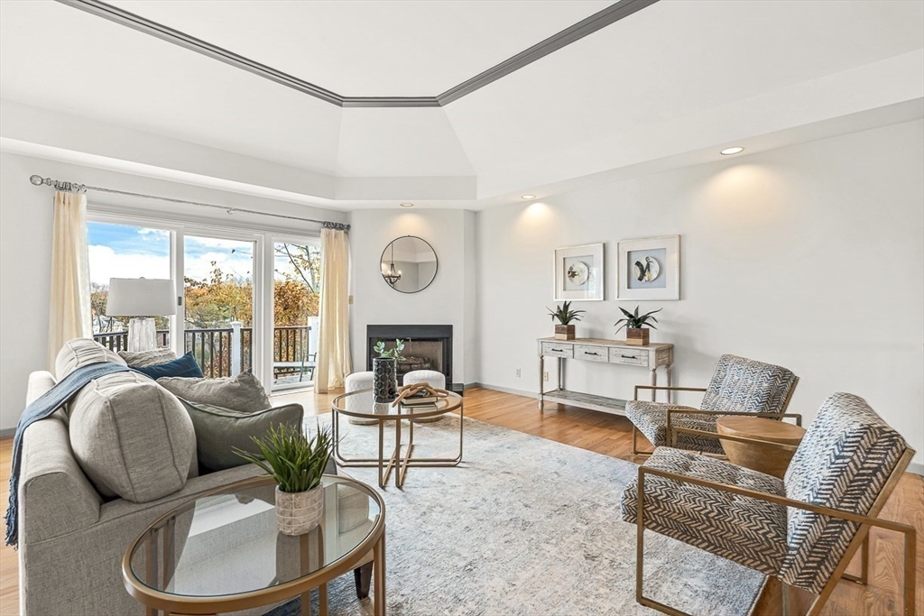 67 Algonquin Road, Unit 67 Newton, MA 02467 - Photo 7 of 38 a living room with furniture a fireplace and a large window