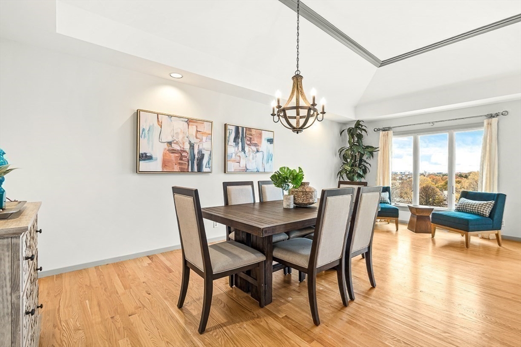 67 Algonquin Road, Unit 67 Newton, MA 02467 - Photo 9 of 38 a view of a dining room with furniture window and wooden floor
