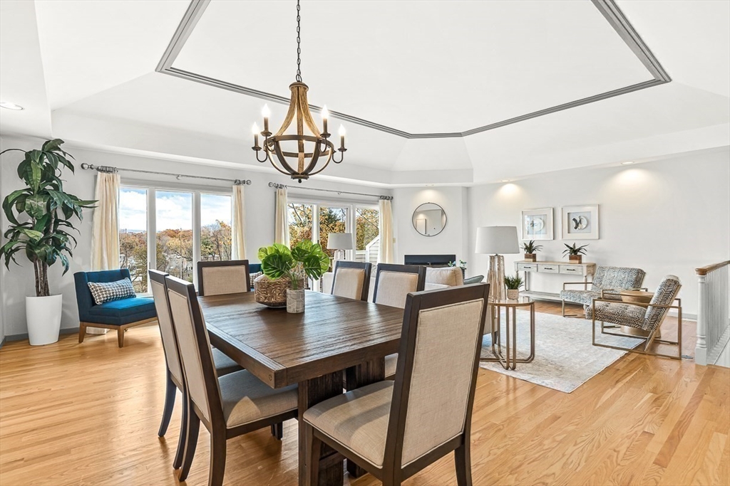 67 Algonquin Road, Unit 67 Newton, MA 02467 - Photo 10 of 38 a view of a dining room and livingroom with furniture wooden floor a chandelier