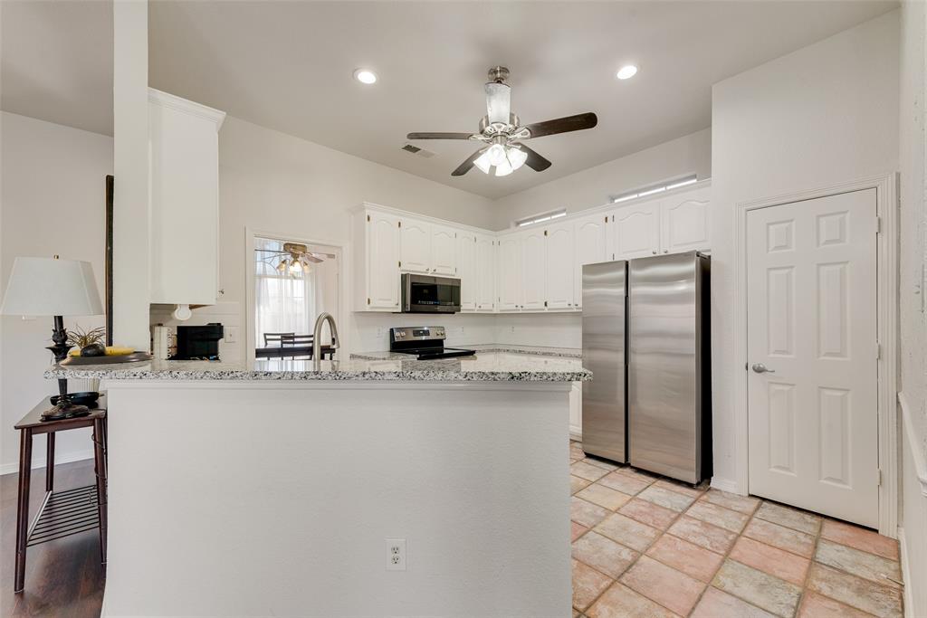 106 Villanova Circle Forney, TX 75126 - Photo 10 of 26 a kitchen with stainless steel appliances a refrigerator and a stove top oven