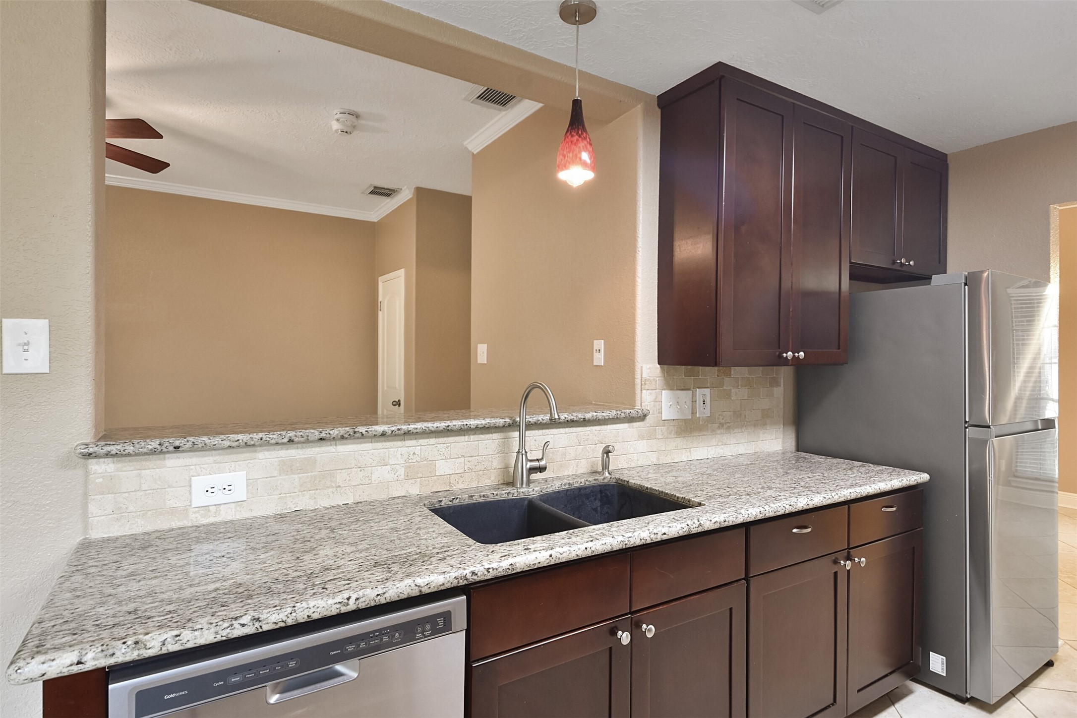 5 East Willowwood Court Spring, TX 77381 - Photo 14 of 27 a kitchen with stainless steel appliances granite countertop a sink refrigerator and cabinets