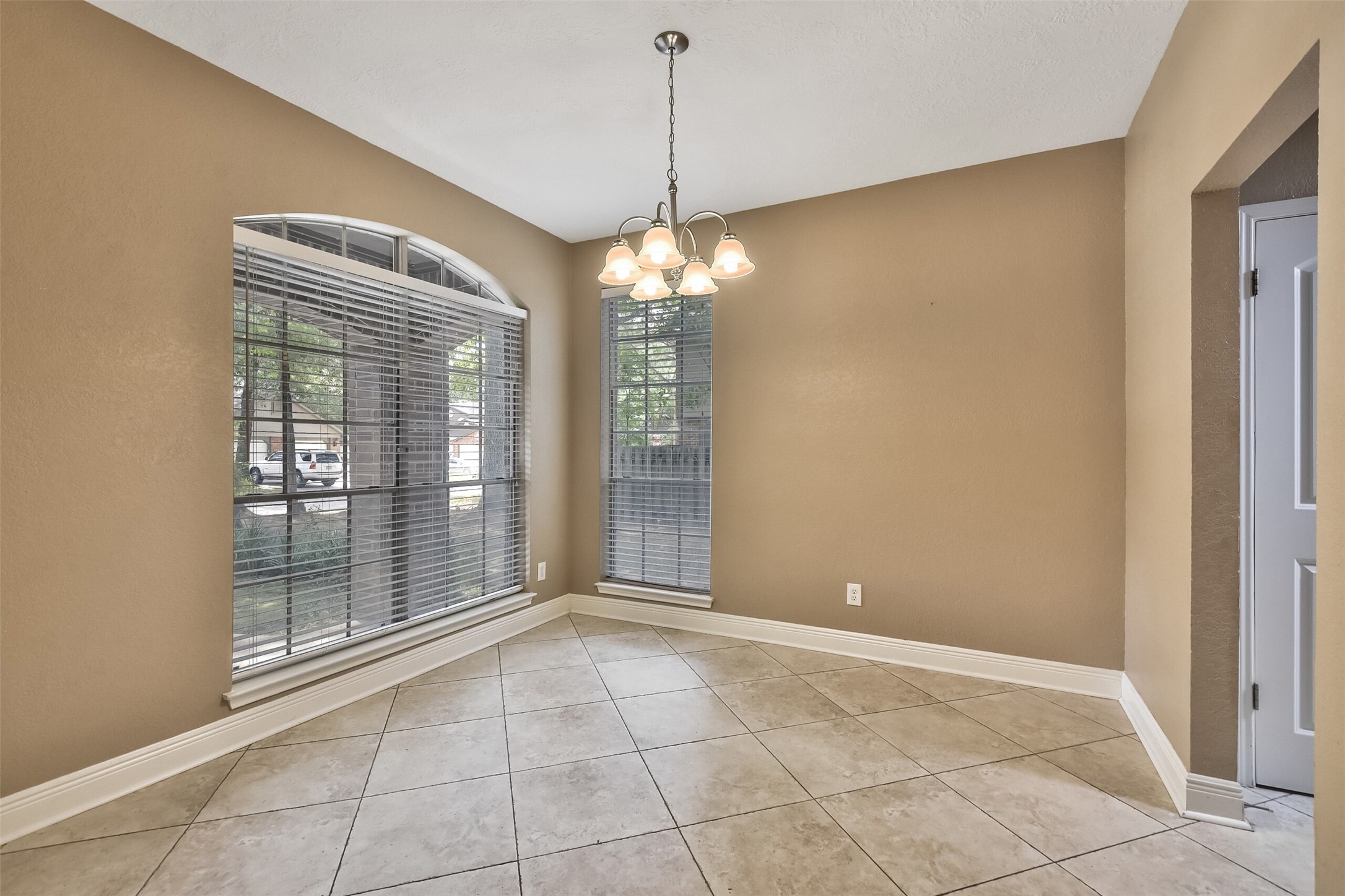 5 East Willowwood Court Spring, TX 77381 - Photo 15 of 27 a view of a room with window and chandelier