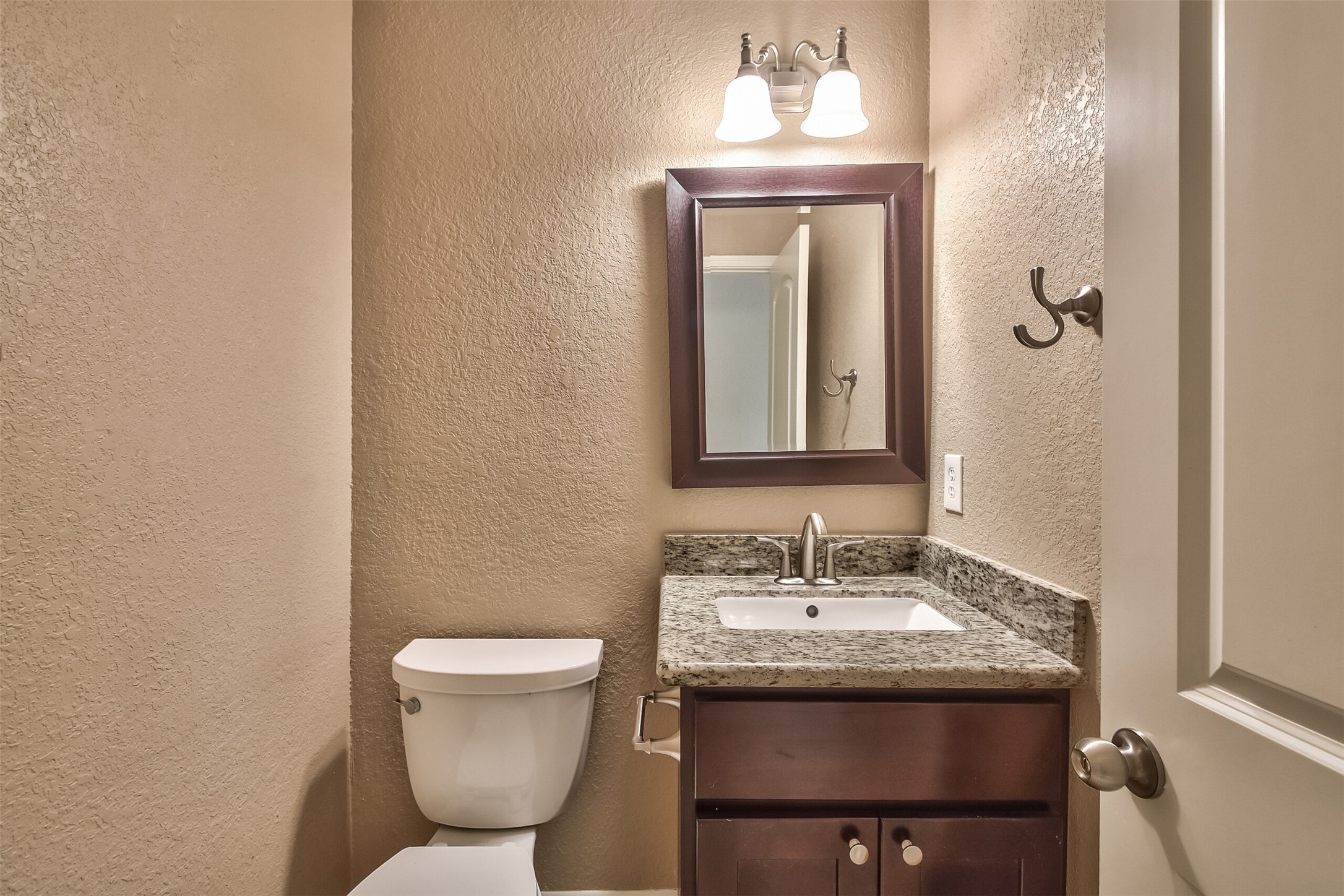 5 East Willowwood Court Spring, TX 77381 - Photo 18 of 27 a bathroom with a toilet sink and mirror
