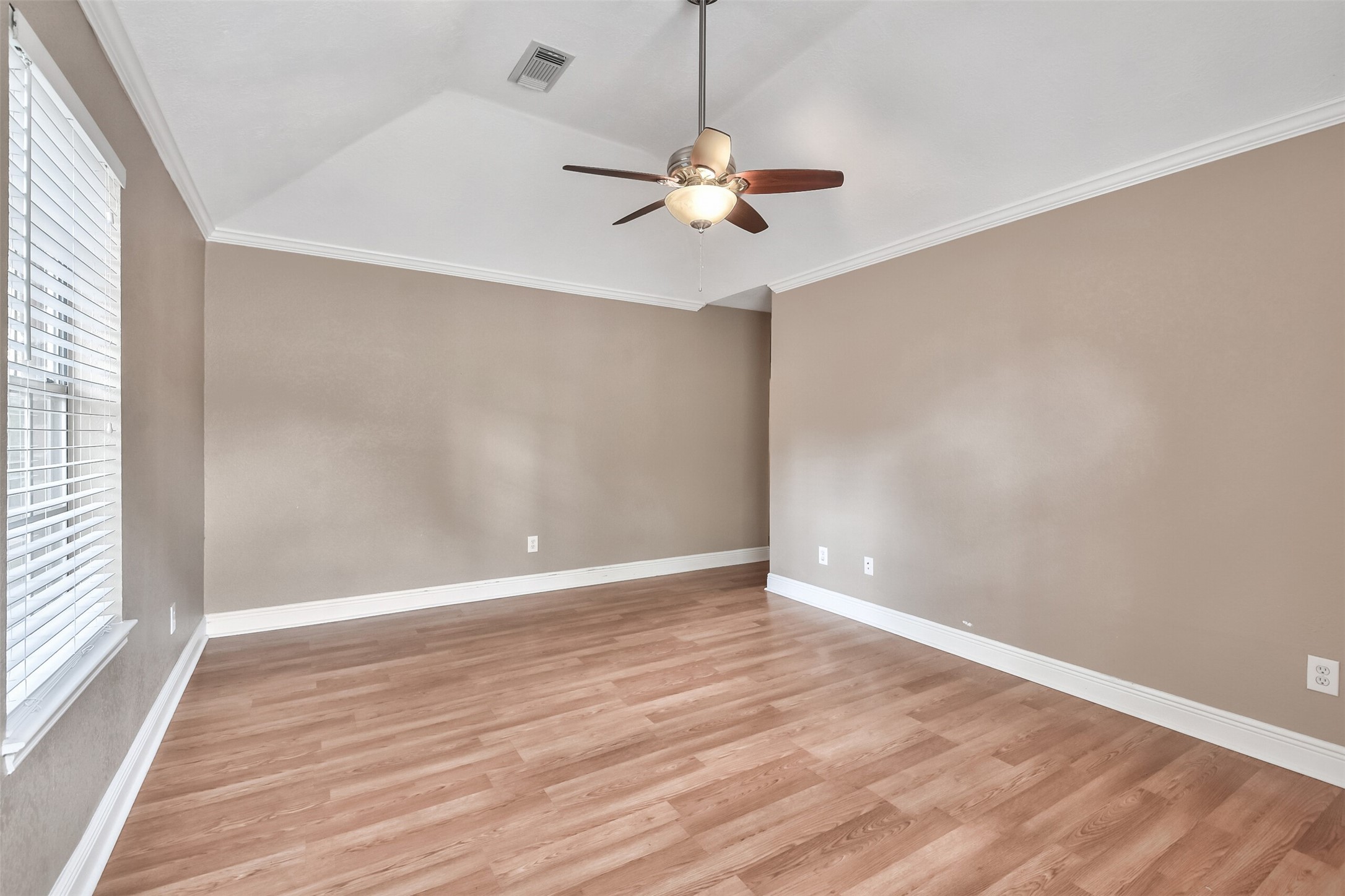 5 East Willowwood Court Spring, TX 77381 - Photo 20 of 27 a view of an empty room with wooden floor and a window
