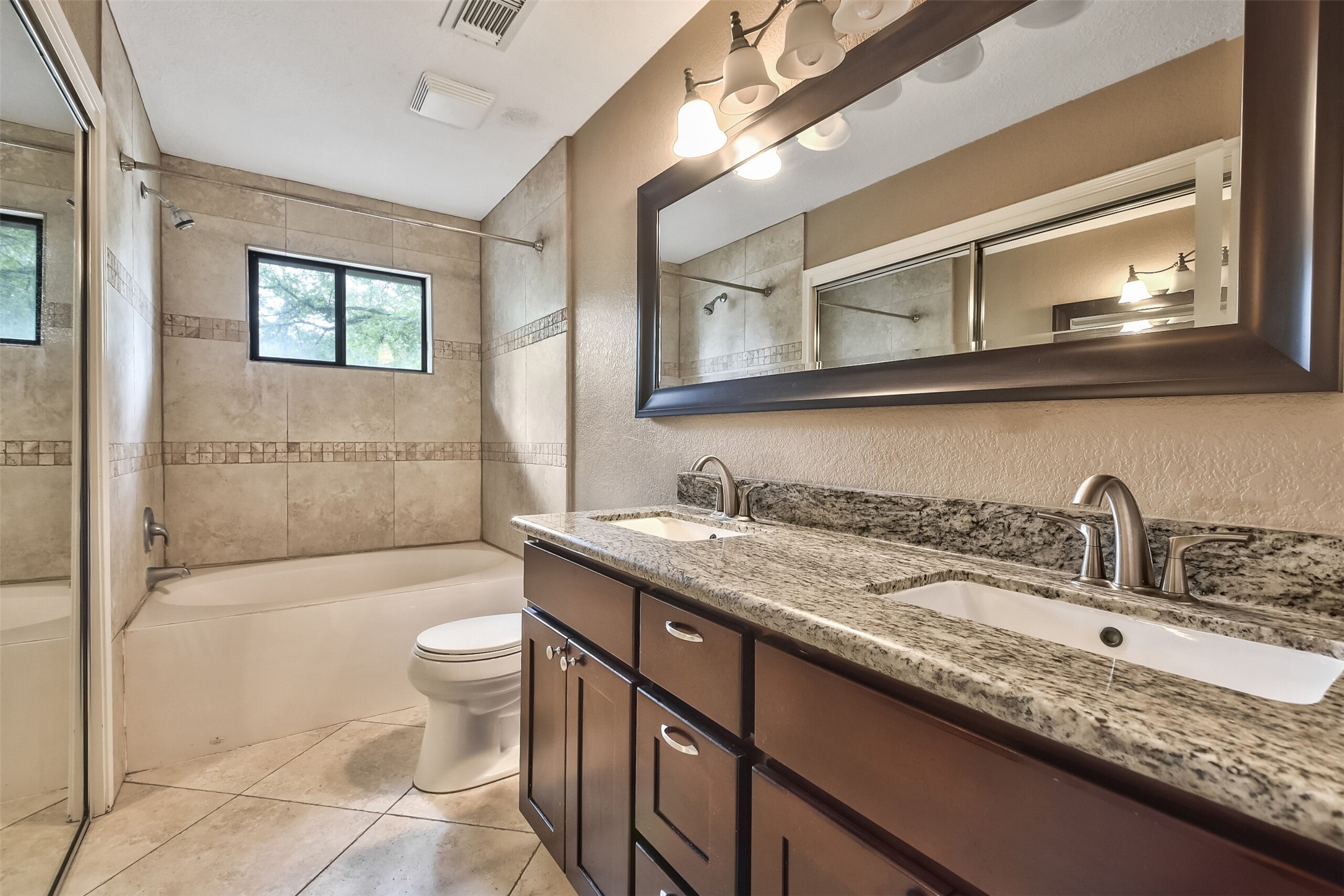 5 East Willowwood Court Spring, TX 77381 - Photo 21 of 27 a bathroom with a granite countertop sink a toilet a mirror and bathtub