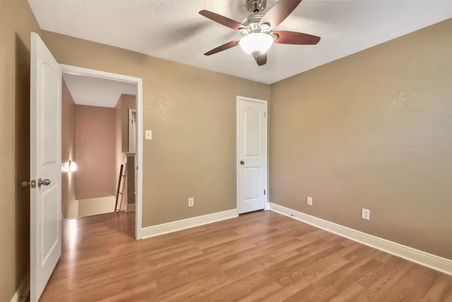 a view of an empty room and wooden floor