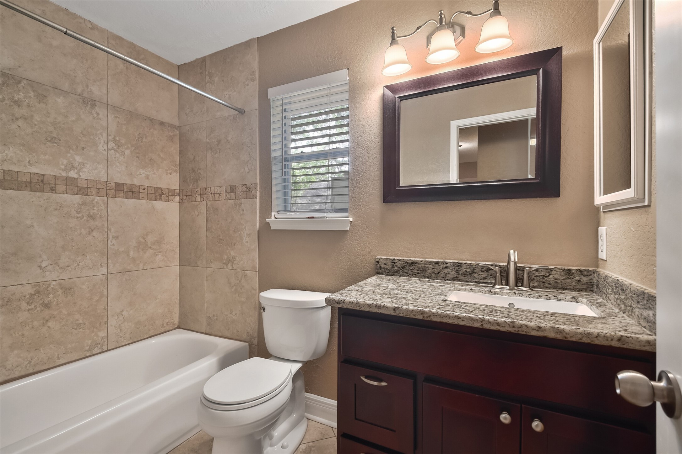 5 East Willowwood Court Spring, TX 77381 - Photo 25 of 27 a bathroom with a granite countertop toilet sink and mirror