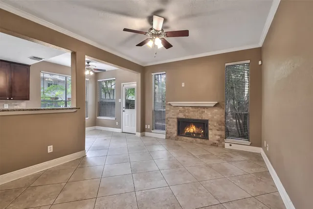 a view of an empty room with a fireplace and a window