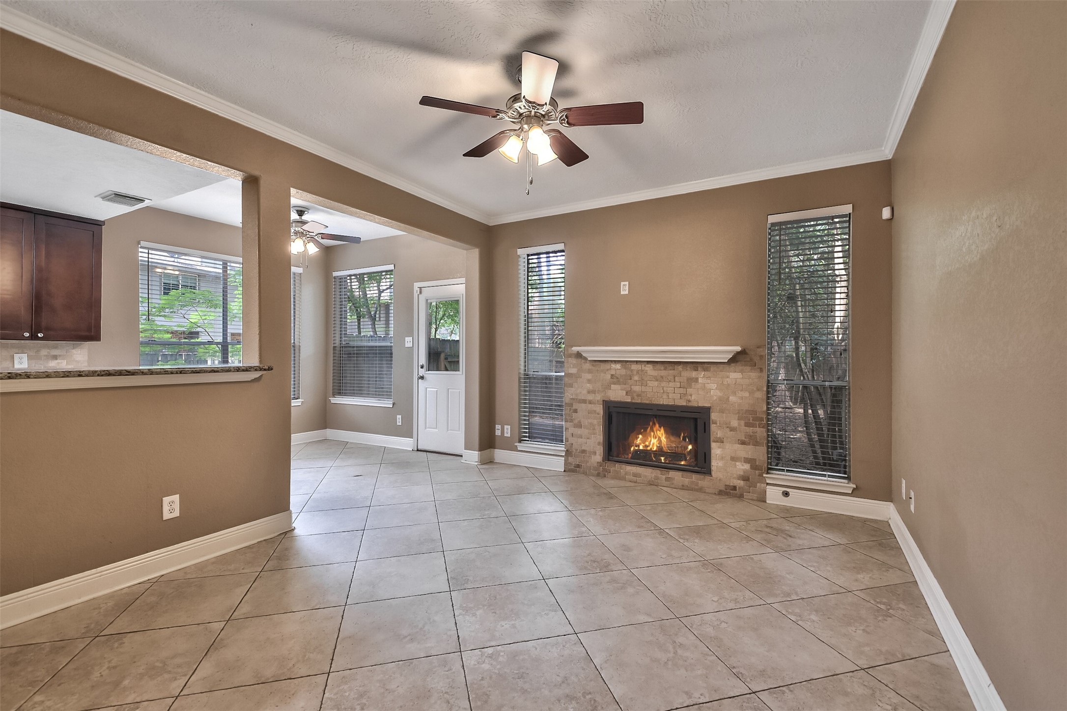 5 East Willowwood Court Spring, TX 77381 - Photo 4 of 27 a view of an empty room with a fireplace and a window